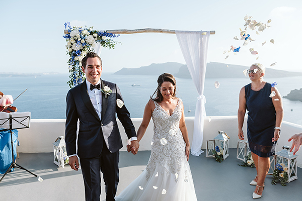 Romantic elopement in Santorini with gorgeous white and blue flowers│ Emily & Derek