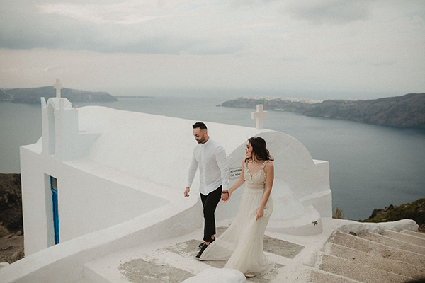 A romantic pastel hued elopement in Santorini with breathtaking views