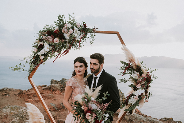 A stunning elopement in Santorini with burgundy hues and a bohemian vibe