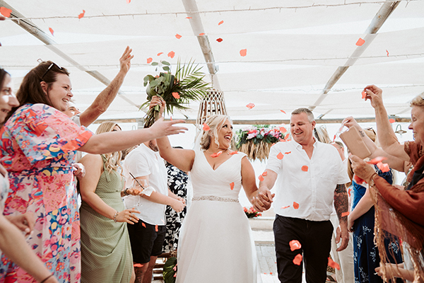 Beach tropical wedding in Paphos with vibrant flowers│ Roxy & John